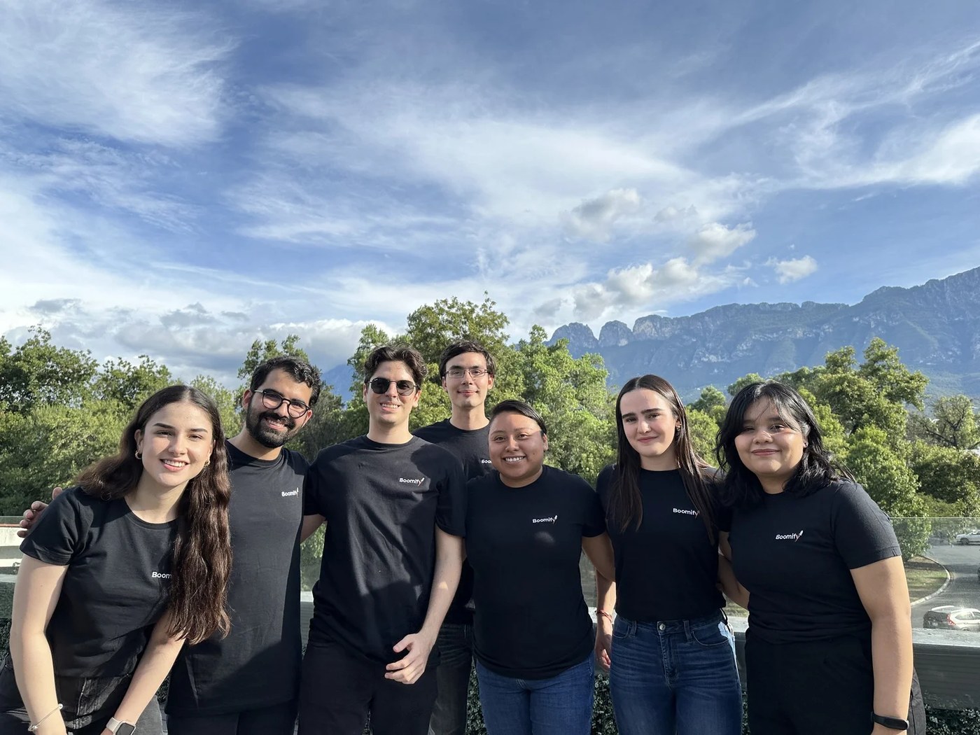 The Boomify team together outdoors in Monterrey, with the Sierra Madre mountains behind them